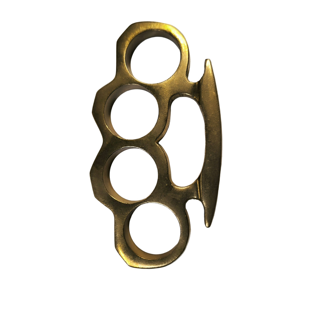 Brass knuckles with a blade on a gray background